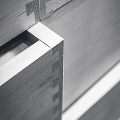 Close-up image of dovetailed joints on a cabinet drawer