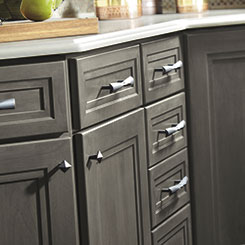 Loring cabinet doors and drawers with coordinating knobs and pulls