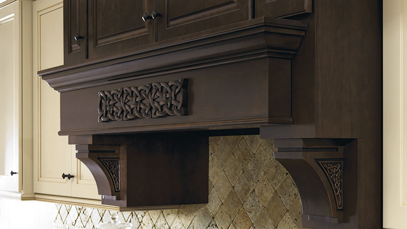 Wood hood with Celtic onlay and corbel accents