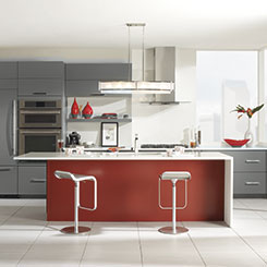 Contemporary kitchen design with Vail cabinets in gray with a red island