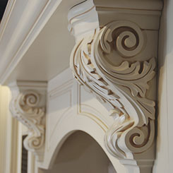 Ornate cabinet corbels in off white with glazed details