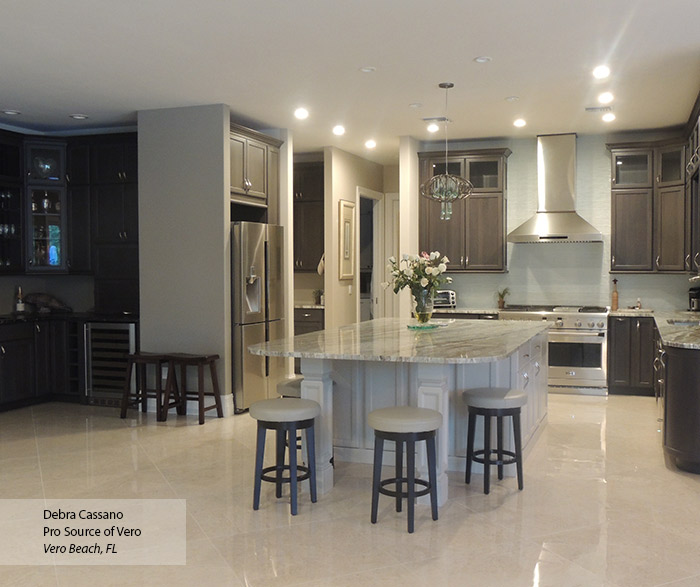 Ultima gray cabinets with an off white kitchen island and bar area