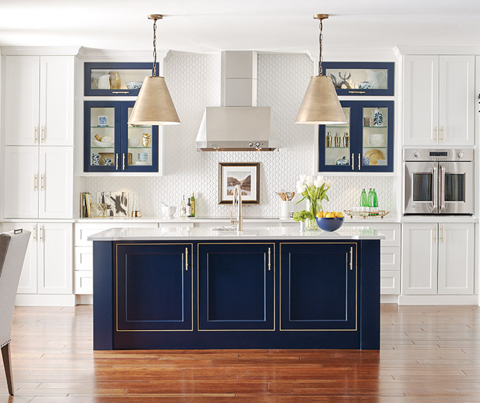 White kitchen cabinets with a custom blue kitchen island in the Renner door style
